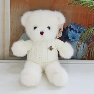 White plush teddy bear toy wearing a knitted sweater, cute stuffed animal doll for kids gift.