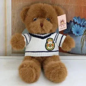 Cute brown teddy bear plush toy wearing a knitted sweater with anchor badge, ideal kid gift.