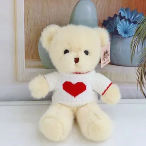 Cute teddy bear plush toy with heart sweater, soft stuffed doll for kids birthday gift.