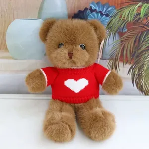 Detailed close-up of a cute plush teddy bear featuring soft brown fur and a red heart sweater.
