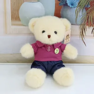 Plush teddy bear toy detailed view, cute stuffed animal wearing stylish purple shirt and shorts.