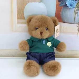 Cute plush teddy bear stuffed toy wearing green polo shirt and blue jeans for kids.