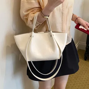 Minimalist cream white bucket bag for women, large capacity stylish commuter shoulder tote.