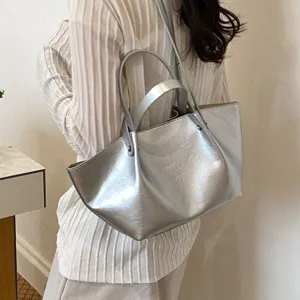 Stylish metallic silver shoulder bag for women, large capacity commuting tote handbag.
