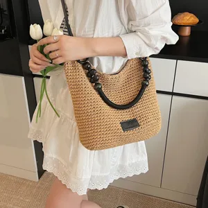 Summer straw woven shoulder bag, large capacity tote with beaded handle and chic style.
