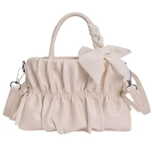 Ruched cloud crossbody handbag for women, chic cream white shoulder bag with cute bow detail.