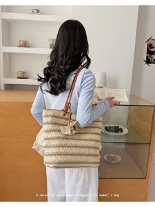 Back view detail of casual straw tote bag in summer lifestyle scene with books and shelves.