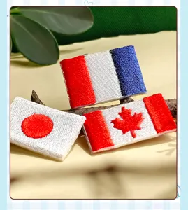 Embroidered national flag patch detail featuring fine stitching for clothing and backpack decor.