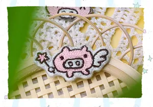 Cute cartoon pig embroidery patch with wings and star wand, perfect for DIY clothing decor.