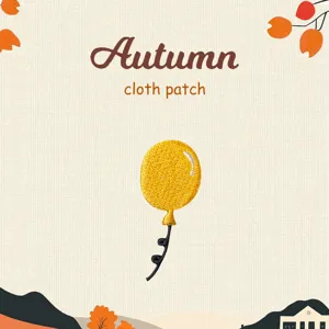 Close-up detail of the cute yellow balloon embroidery cloth patch, perfect for DIY clothing decoration.