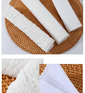 Soft white car seat belt shoulder pads puff embossed strap cover detail close up view