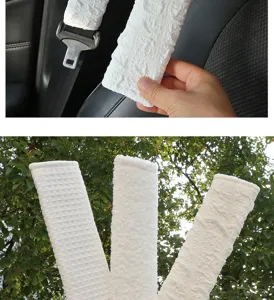 Detailed view of soft textured car seat belt shoulder pads, comfortable driving pad.