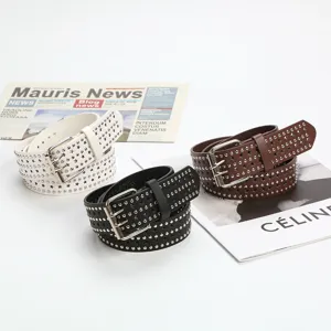 Detailed view of PU leather belt with star cutouts, metal studs and pin buckle for jeans.