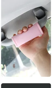 Pink plush car roof grab handle cover soft interior armrest protection detail view.