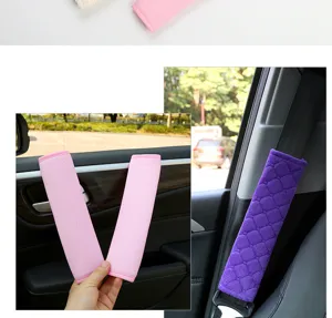 Plush car seat belt cover detail, soft diamond pattern shoulder cushion in pink and purple.