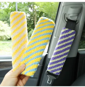Colorful plush car seat belt shoulder pad detail in vibrant stripes and soft lamb wool fabric.