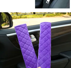 Detail shot showing plush purple quilted car seat belt shoulder pads, soft and comfortable cover.