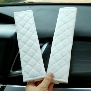 Plush car seat belt shoulder pads, soft quilted interior protective covers for comfortable driving.