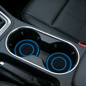 Detailed view of black and blue honeycomb anti-slip car cup holder mat for center console.