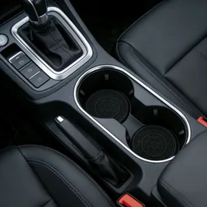 Car anti-slip cup mat detail showing honeycomb texture inside vehicle center console.