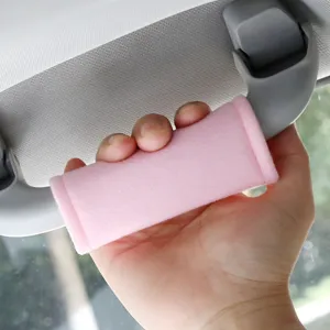 Pink plush car roof grab handle cover, soft interior protective accessory for auto ceiling handle.