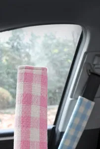 Car seatbelt shoulder pad, coarse-spun plaid fabric, soft and comfortable interior auto accessory.