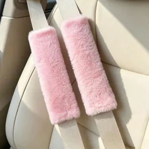 Soft pink faux fur car seat belt cover detail, plush shoulder protector for comfortable driving.