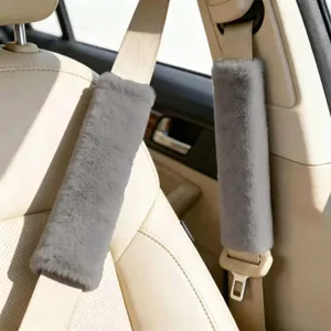 Grey faux fur car seat belt covers, soft plush shoulder pads for comfortable driving protection.