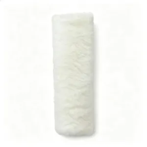 Detailed close-up of white plush seat belt cover, soft fluffy texture for car comfort.