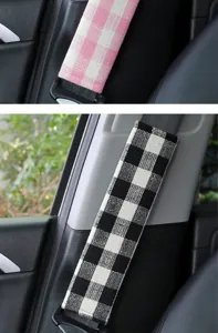 Car seat belt shoulder cover detail shot, soft coarse-spun plaid fabric, comfortable driving accessory.