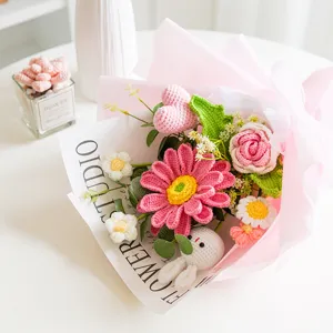 Handmade crochet flower bouquet with cute doll, pink roses and daisies for gift and decor.