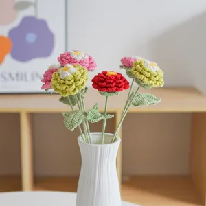 Handmade crochet flower bouquet detail, colorful knitted floral arrangement in white vase.