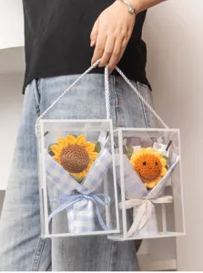 Handmade crochet sunflower bouquet in clear gift box, detail view of cute floral gift.