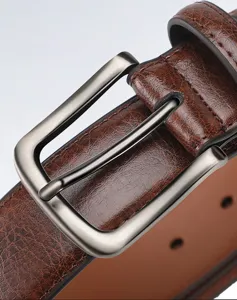 Men's retro genuine leather belt detail close-up, premium cowhide strap with silver pin buckle.