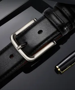 Leather belt detail close-up, black cowhide texture with matte silver metal pin buckle.