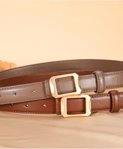 Detailed shot of women genuine leather belt featuring elegant gold geometric buckle accessory.