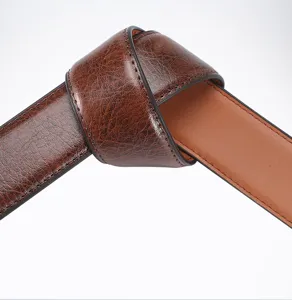 Close-up detail of textured brown leather belt showing fine stitching and premium quality.