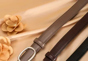 Detailed close-up of women's thin genuine leather belts in multiple colors with metal buckles.