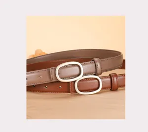 Detailed view of women's genuine leather thin belt with elegant oval metal buckle design.