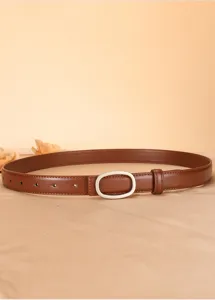Detail view of brown genuine leather women belt with silver oval buckle, simple stylish design.