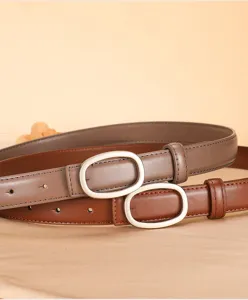 Close-up detail of women's genuine leather thin belts with elegant oval metal buckles set.