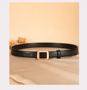 Detail shot of the women's black genuine leather belt featuring an elegant golden geometric buckle.