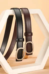 Women's genuine leather slim belt detail view showcasing black and brown designs with oval buckles.