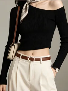 Detail shot of women's genuine leather thin belt with oval metal buckle, stylish.