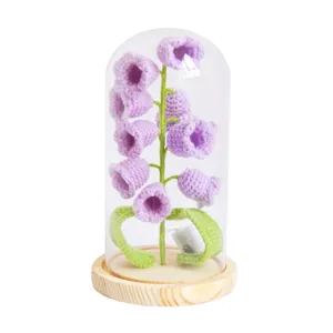 Handmade crochet purple flower in glass dome with wooden base, desktop decor ornament main view.