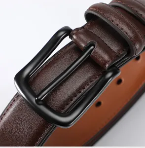 Men's leather belt detail shot, dark brown cowhide strap with black metal pin buckle.