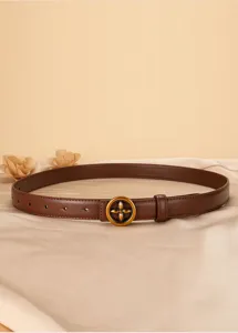 Detailed view of women genuine leather brown belt featuring retro gold floral metal buckle.