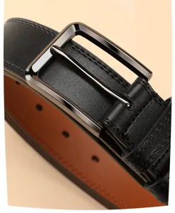 Close-up detail of men's black leather belt with metal pin buckle and textured strap.