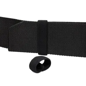 Close-up detail of black tactical belt nylon webbing and elastic keeper loop for outdoor gear.