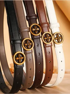 Close-up detail of luxury style thin leather belt with iconic flower metal buckle in multi colors.